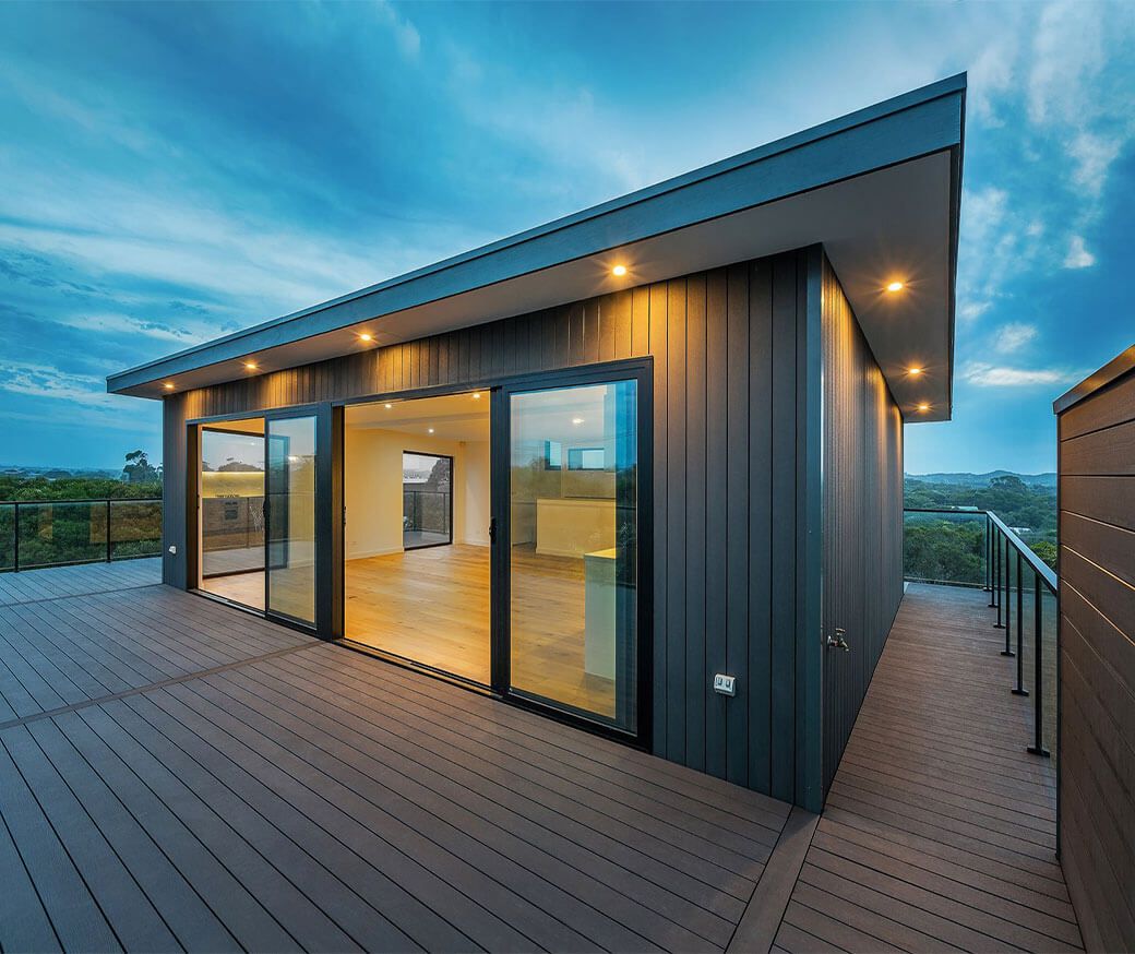 Modern garden with grey composite decking, outdoor seating and raised planting