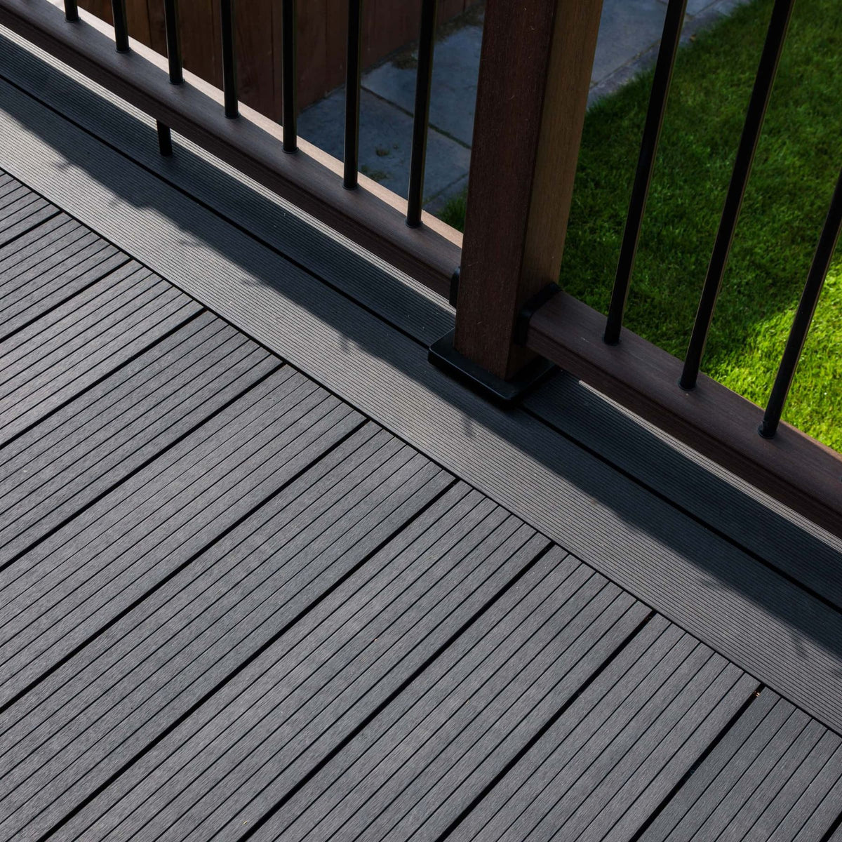 Grey composite decking with outdoor kitchen, dining area and pergola